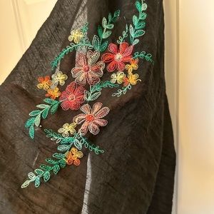 Black embroidered scarf. Floral details on both ends.